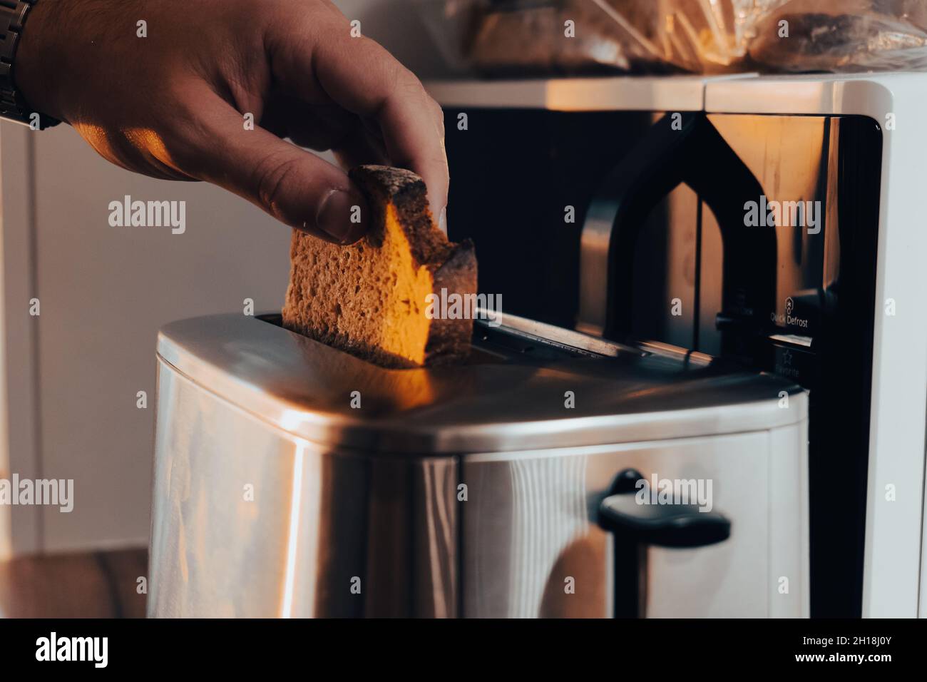 Toasting rye bread, healthier alternative to white bread Stock Photo