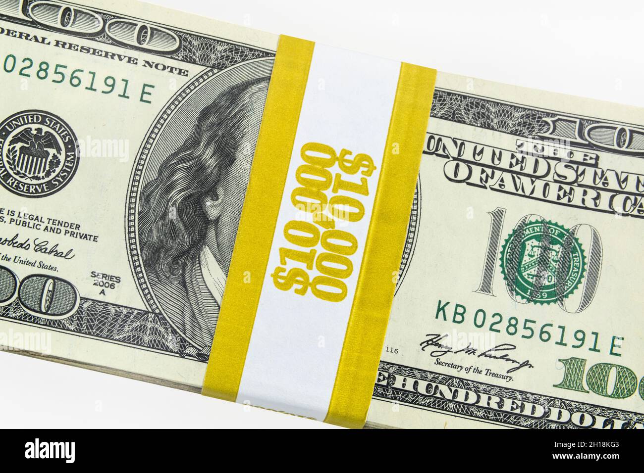 One hundred bill money bundle with $10000 paper currency strap. Stock Photo