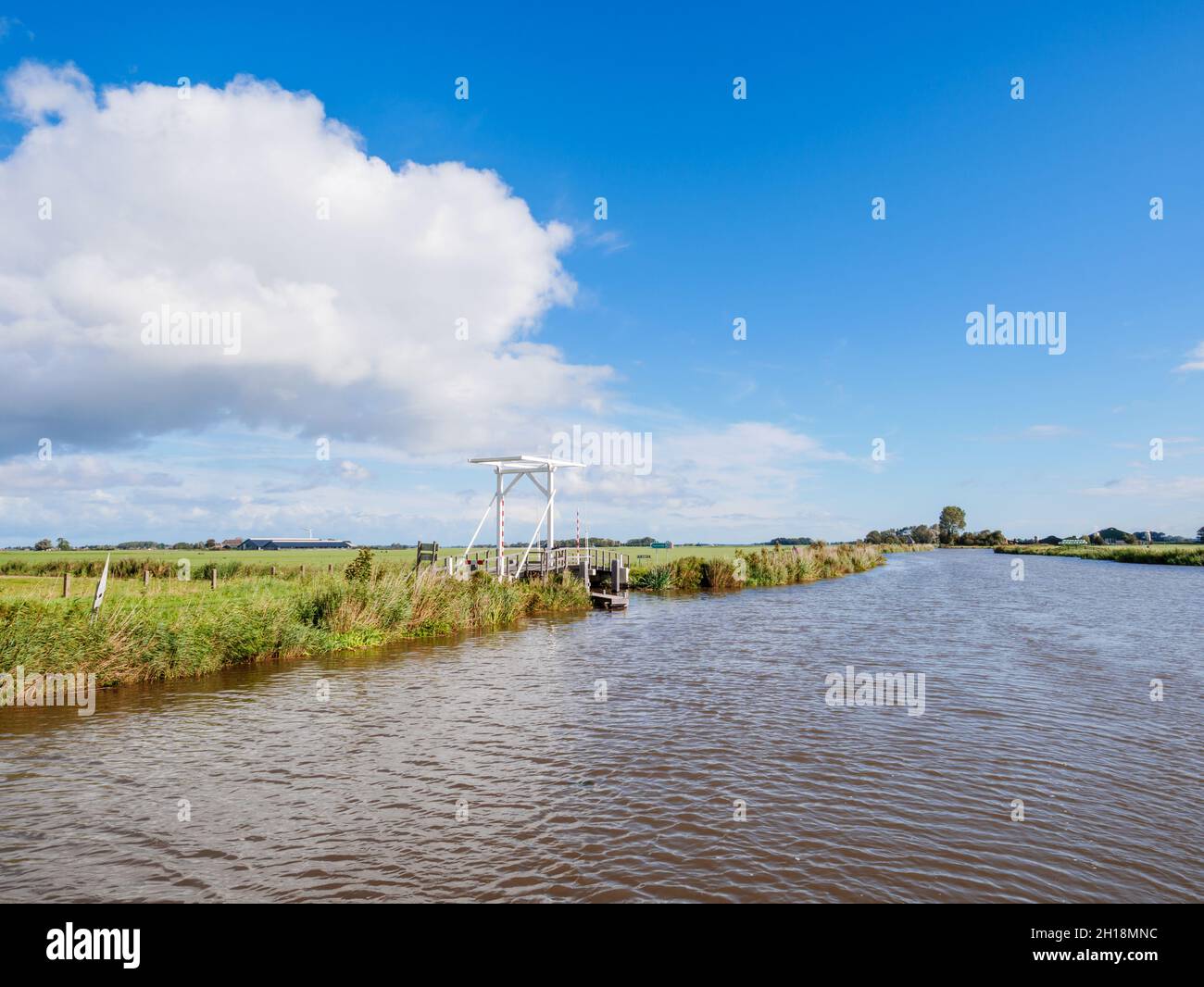 Panorama of Dokkumer Ee canal, drawbridge and polder landscape in Friesland, Netherlands Stock Photo