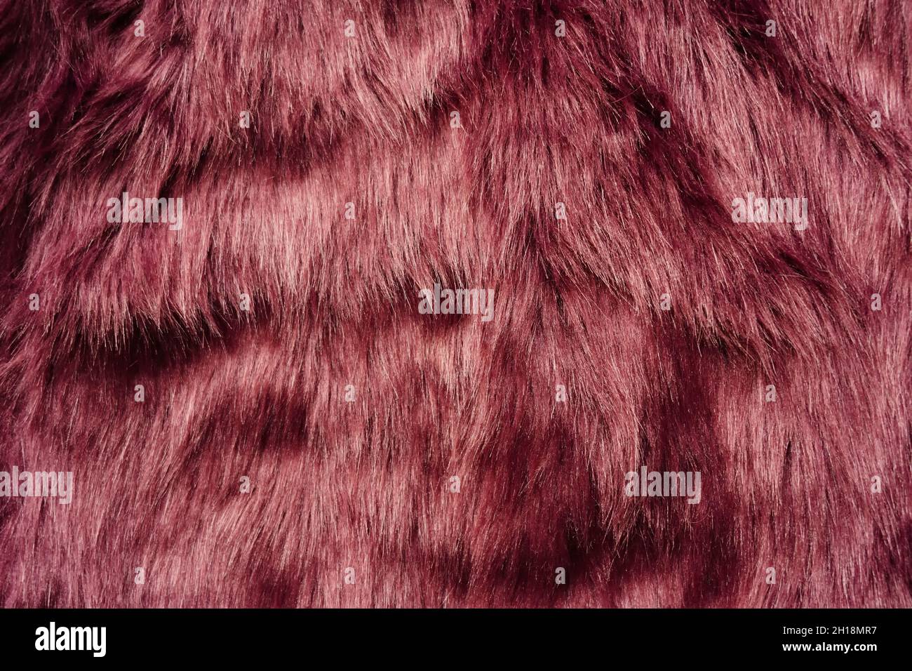 Cosy berry-coloured fake fur background. Stock Photo