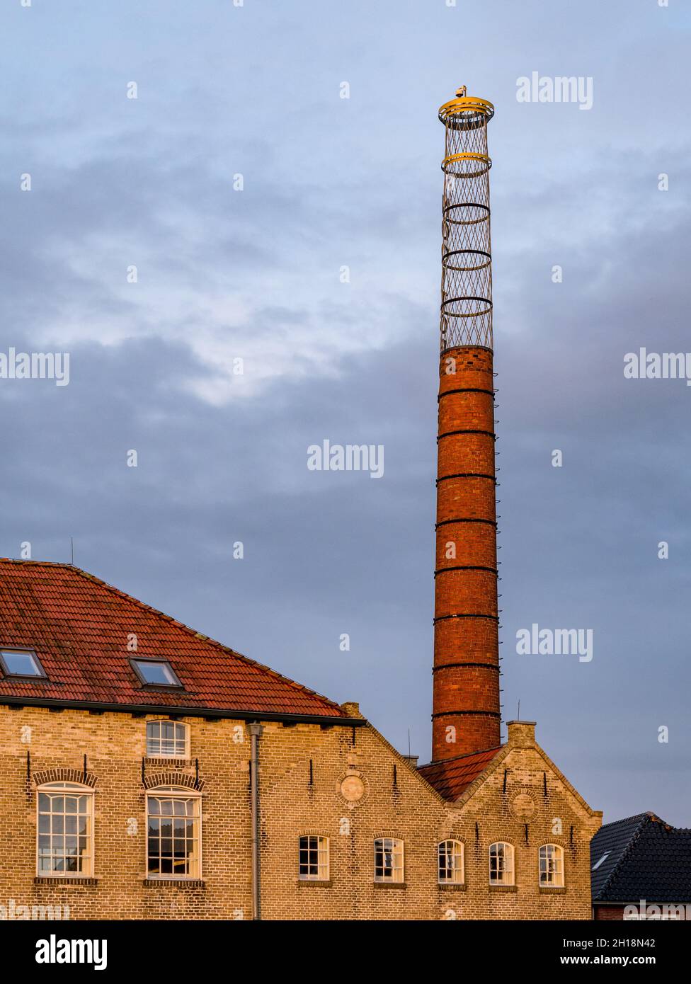Chimney of former ice skate factory Nooitgedagt in city of IJlst, Friesland, Netherlands Stock Photo