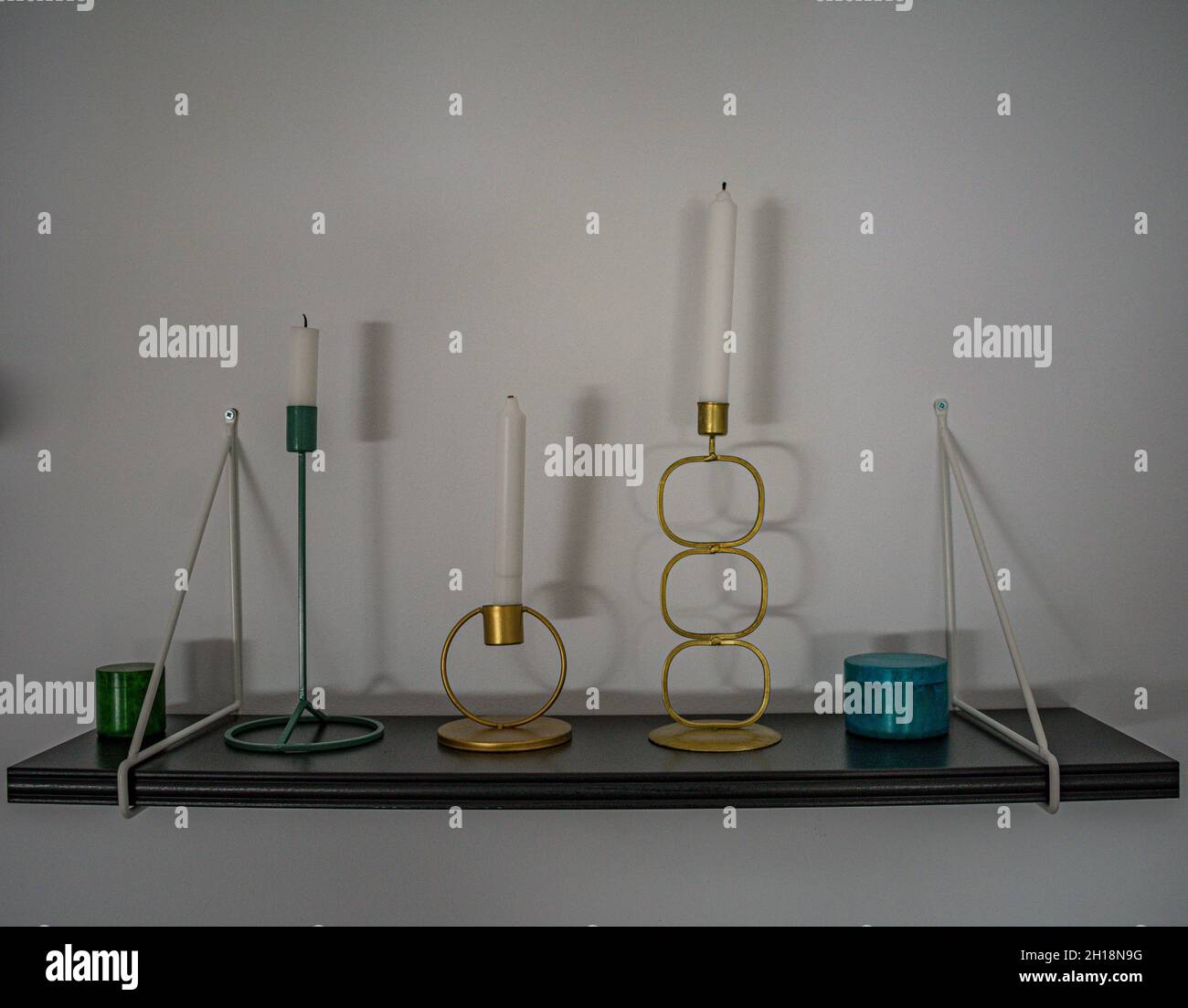 Different decorative candles with candleholders of different shapes and