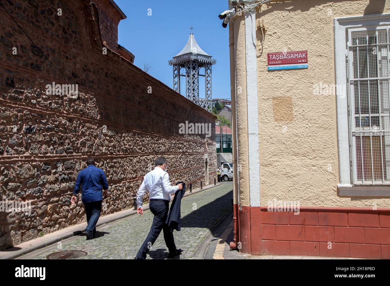 Istanbul,Turkey - 05-25-2021:An old street in Ortakoy district. View of Surp Asdvadzadzin Armenian Church bell tower Stock Photo