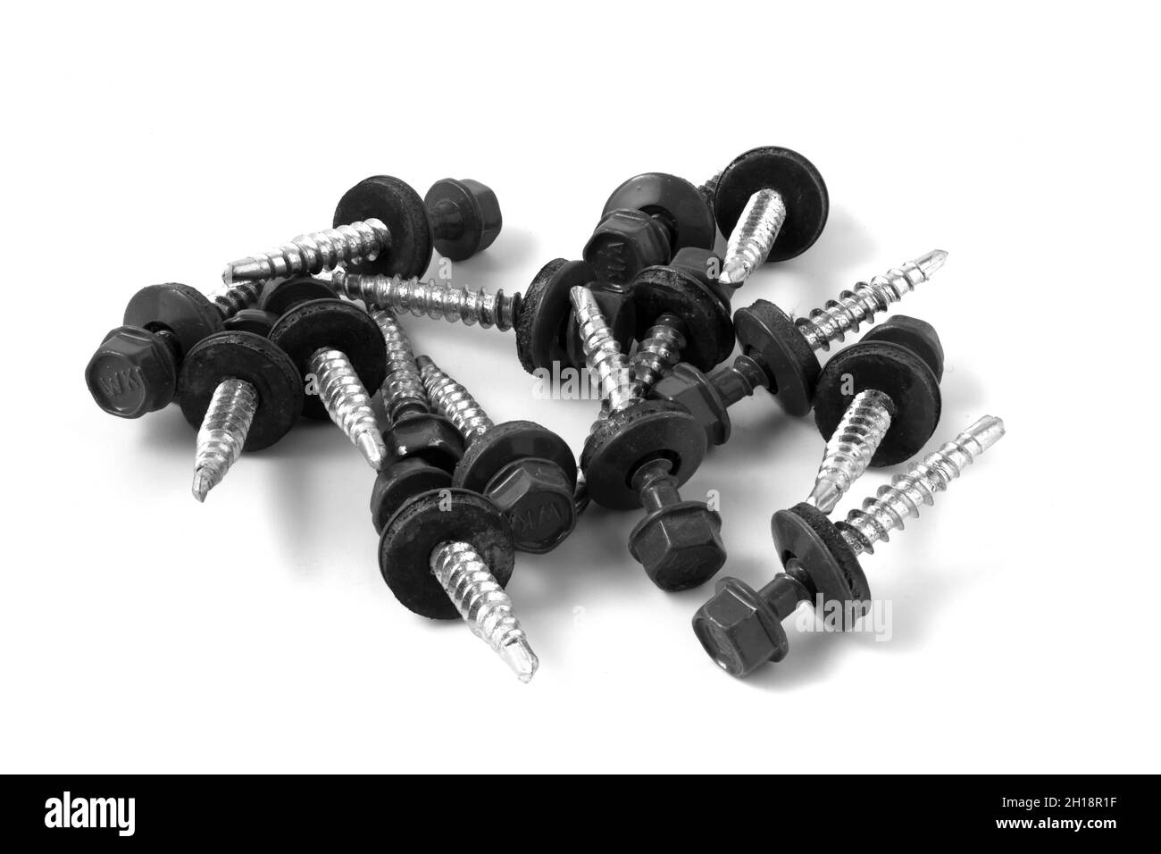 Metal roofing screws. Black screws on metal isolated on white background Stock Photo