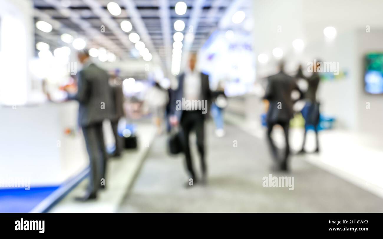 Defocused bokeh abstract of businesspeople at generic trade show expo stand - Business and social gathering concept at international tourism tradeshow Stock Photo