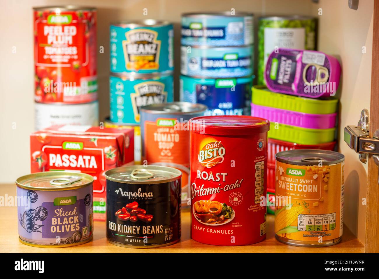 https://c8.alamy.com/comp/2H18WNR/tinned-or-canned-foodstuffs-in-a-uk-kitchen-cupboard-stocked-up-storage-provisions-2H18WNR.jpg