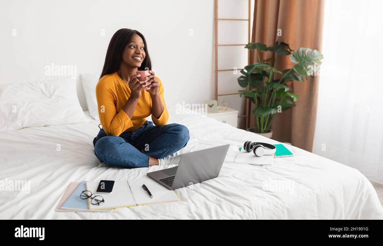 African American Lady Using Laptop Enjoying Coffee In Bedroom, Panorama ...