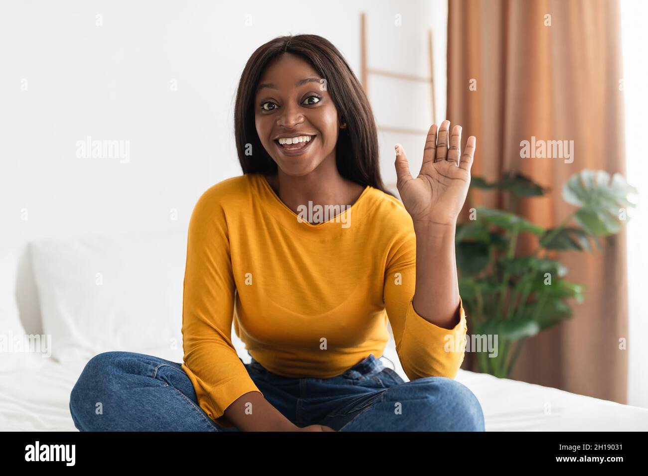 Black Female Waving Hand Communicating Via Video Call At Home Stock ...