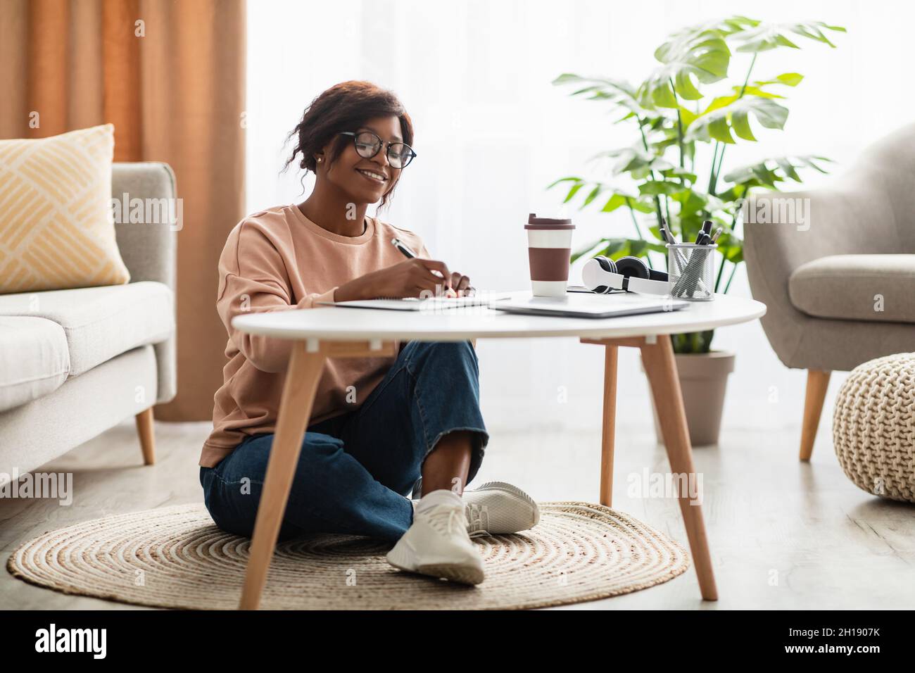 Cheerful Black Millennial Lady Writing Taking Notes Learning At Home Stock Photo