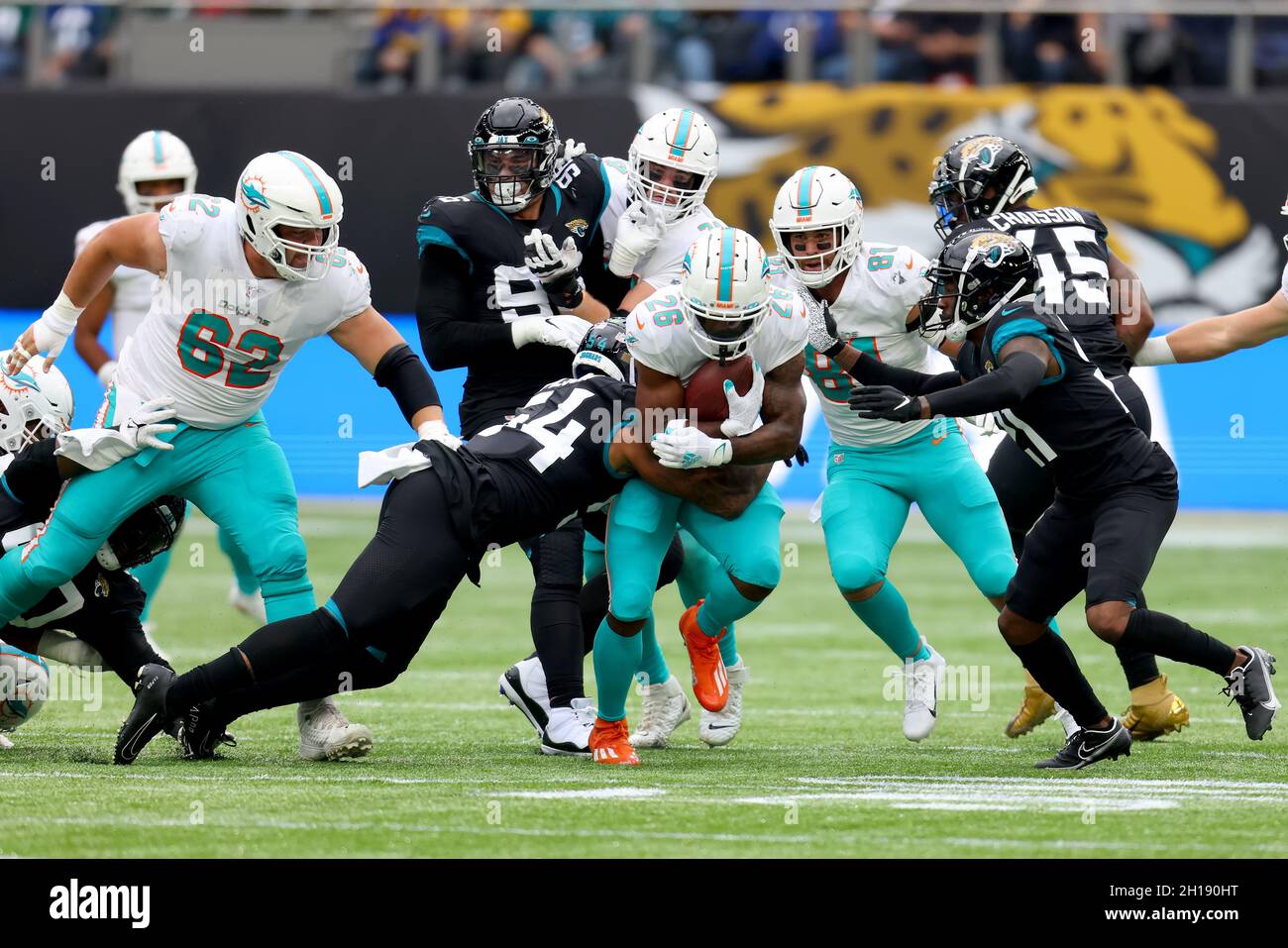 Miami Dolphins running back Salvon Ahmed (26) breaks the tackle of Raiders  defensive tackle Mau …