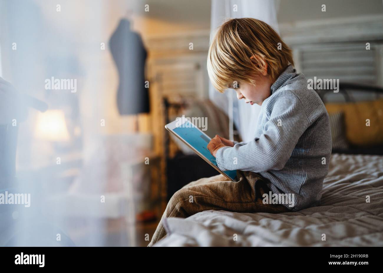 Young boy using a tablet computer at home Stock Photo