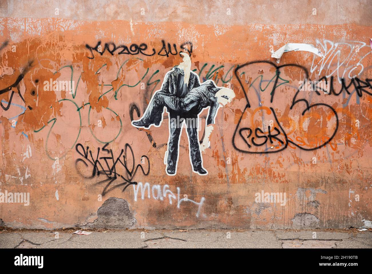 Street art. Torn cut-to-shape paste-up posters in Trastevere district of Rome, Italy. Stock Photo