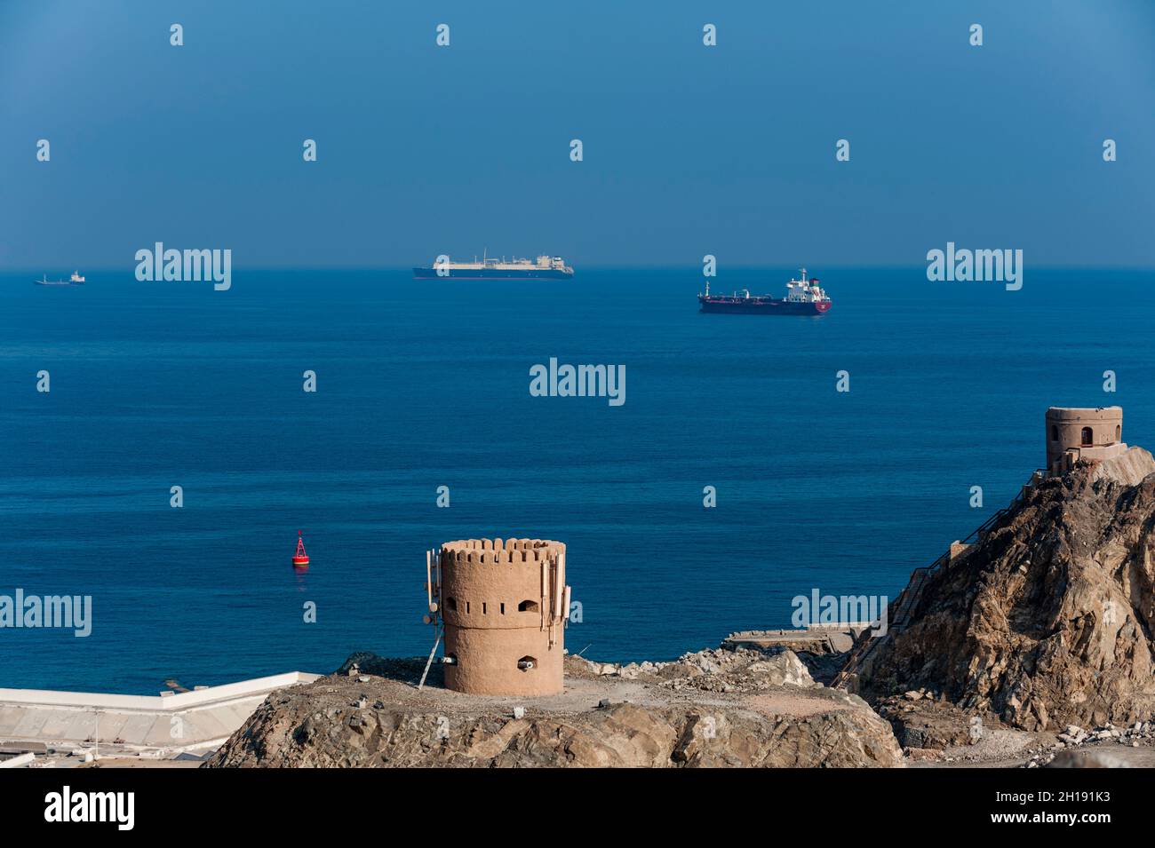 Commercial ships anchored off the coast of the Mutthra district harbor. Mutthra District, Muscat, Oman. Stock Photo