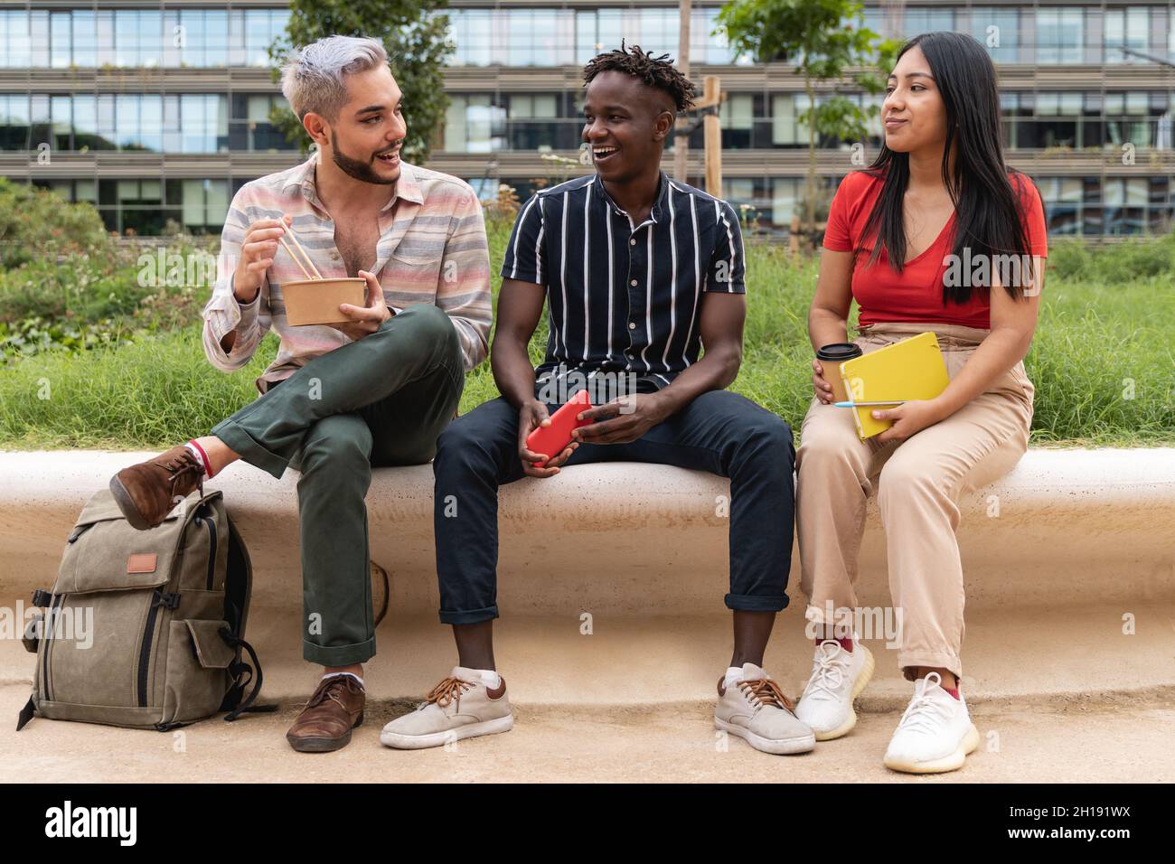 Diverse people having fun eating takeaway food outdoor in the city