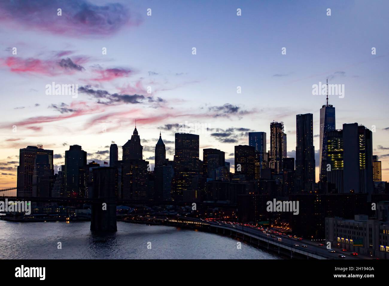 View of the buildings of the Manhattan skyline at dusk in New York City ...