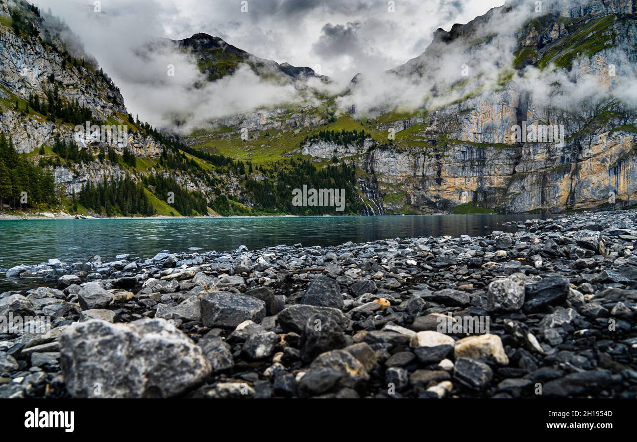 A fascinating view of a river among the mountains on a foggy day Stock ...