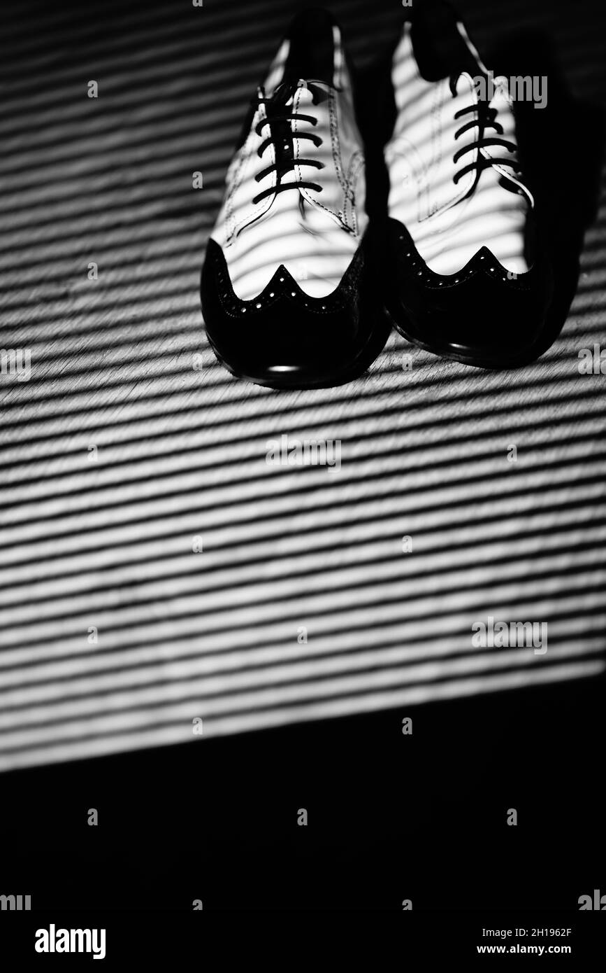 Male dancer teacher dancing in nightclub ballroom in jazz dance shoes. Stock Photo