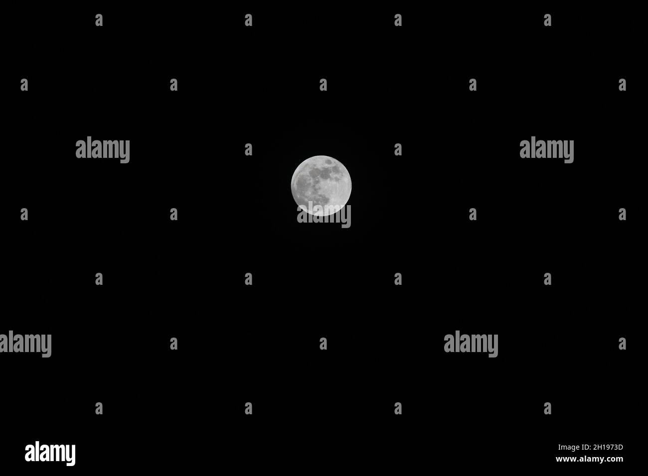 A bright, full moon in the dark night sky Stock Photo - Alamy