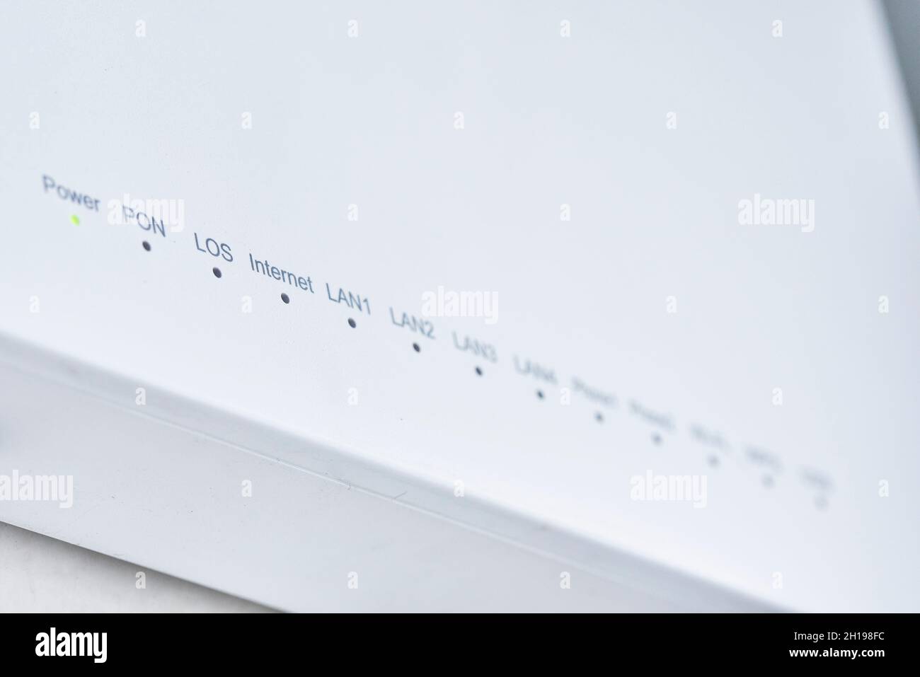 Close-up view of Internet wi-fi router device. Icons on the Wi-Fi router indicating the signal and connection. Wi-Fi modem router. Fast internet modem Stock Photo