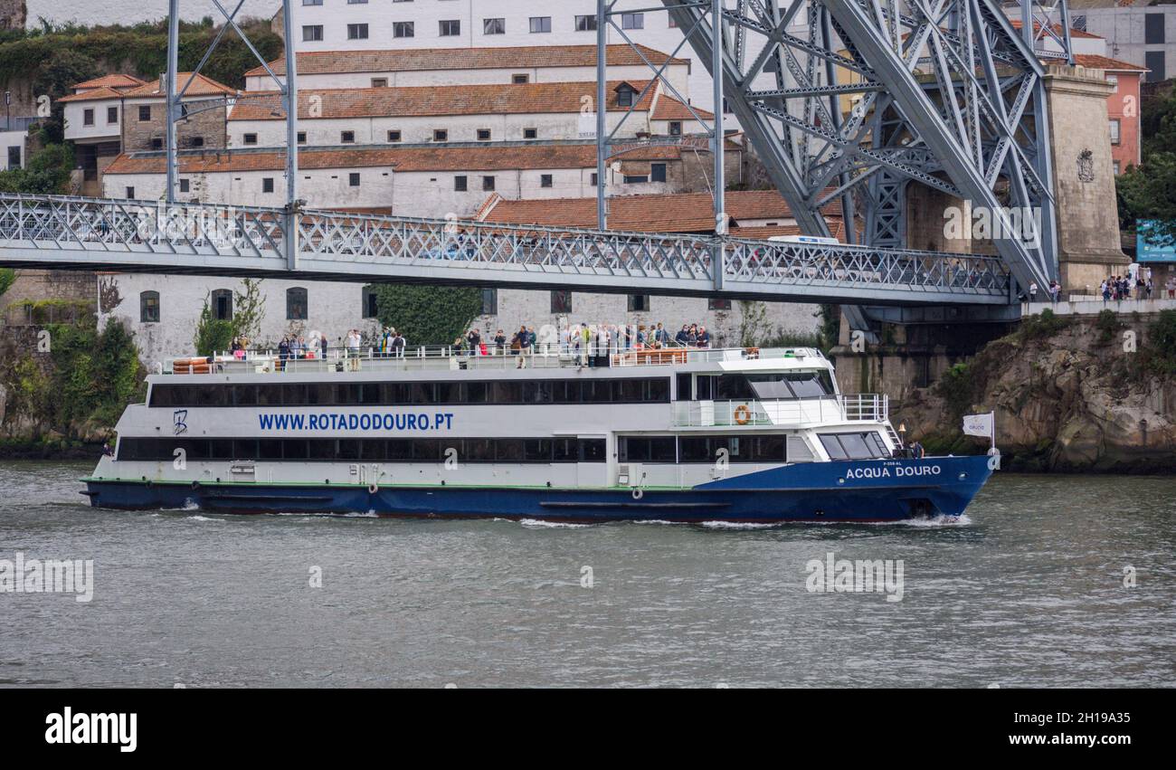 Tourist boat on Douro river near Dom luis I Bridge, Porto, Portugal. Stock Photo