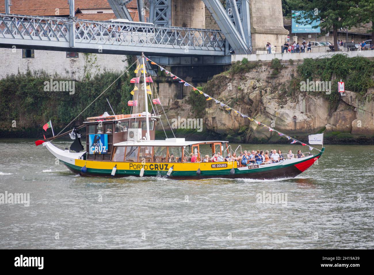 Tourist boat on Douro river near Dom luis I Bridge, Porto, Portugal. Stock Photo