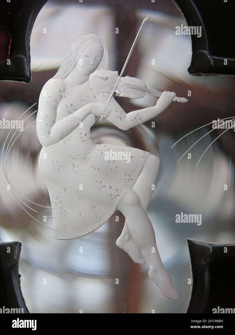 Images of Scotland: glass engraving of a girl playing the fiddle; commission by sculptor Alison Kinnaird for the conservatory doors at Mount Stuart Stock Photo