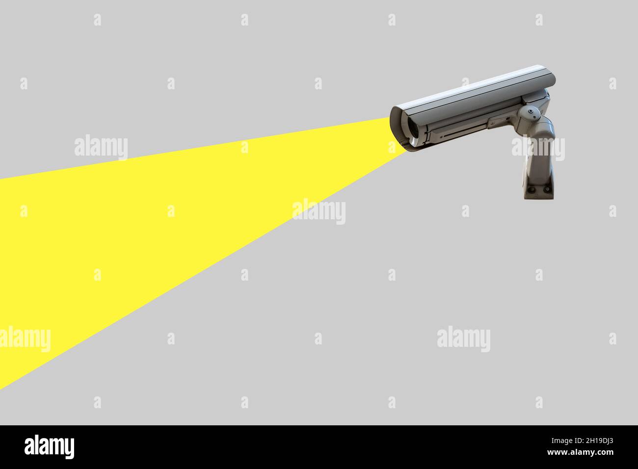Security camera on gray wall. Minimal creative concept. Stock Photo