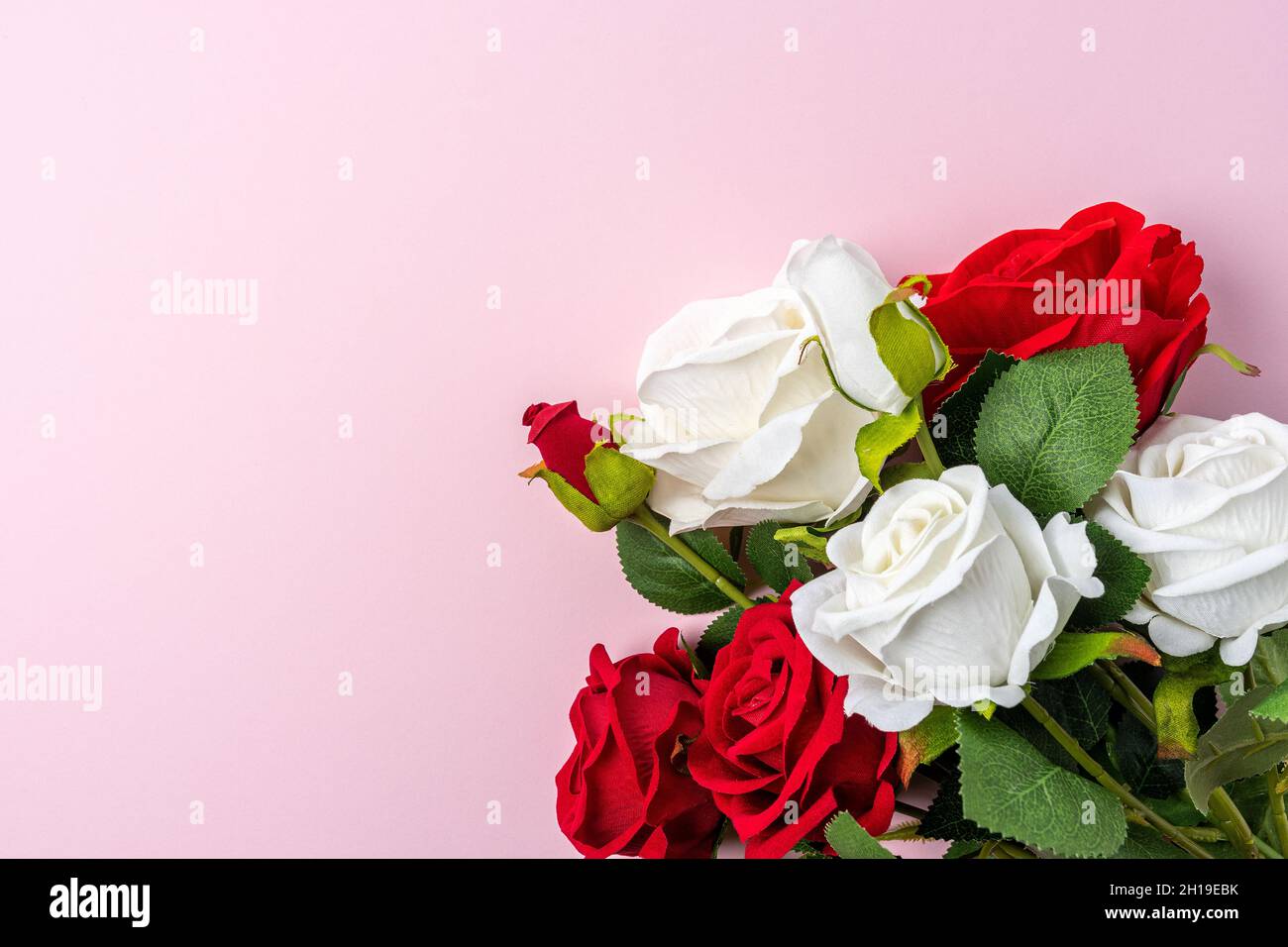 Creative layout made with flowers on pink backdrop. Spring minimal concept. Stock Photo