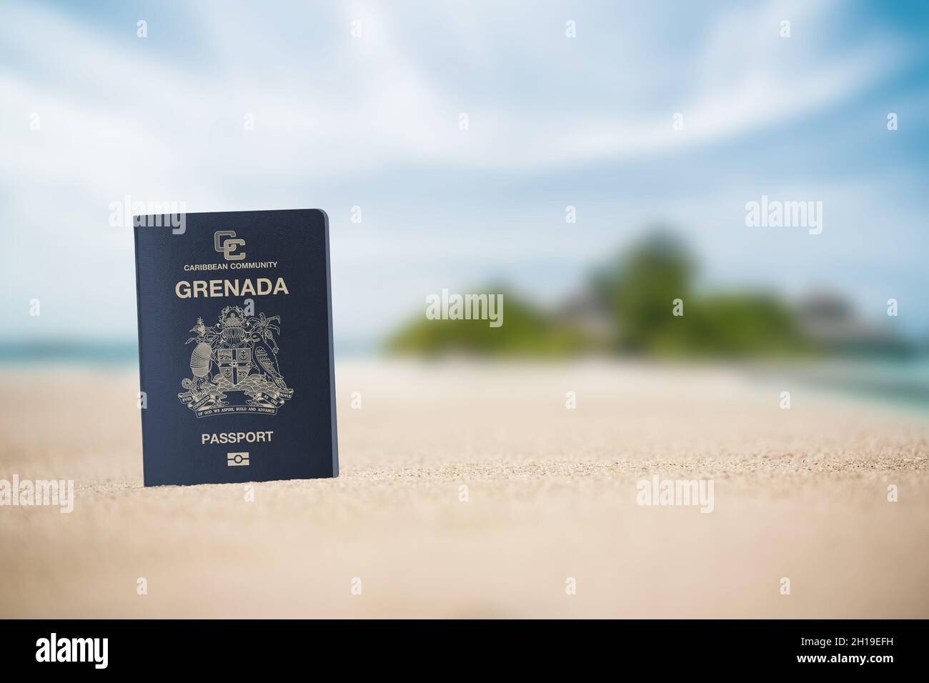Grenada passport on the beach sand ,Space for writing Stock Photo