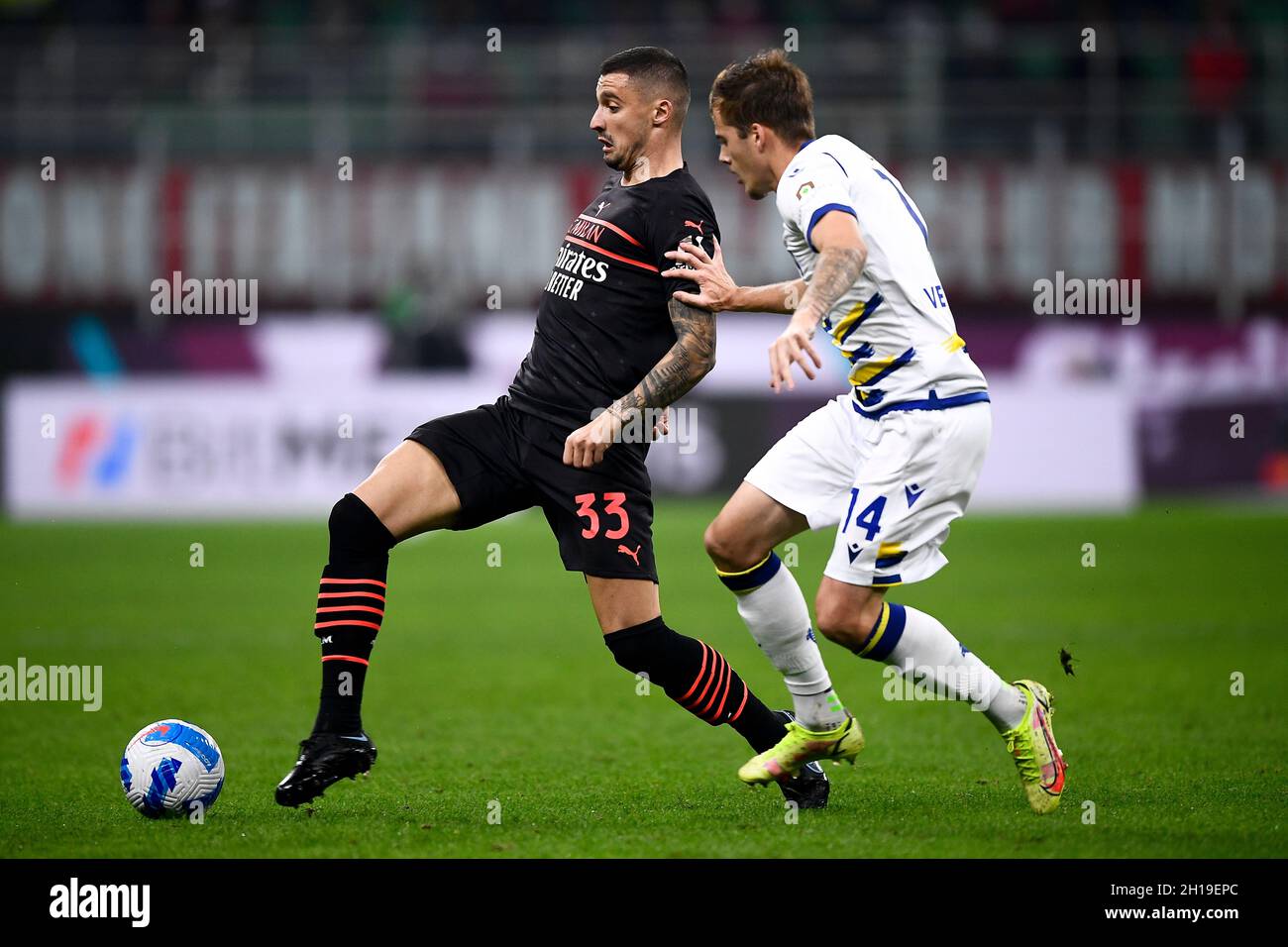 Milan, Italy. 16 October 2021. Rade Krunic (L) of AC Milan is challenged by Ivan Ilic of Hellas Verona FC during the Serie A football match between AC Milan and Hellas Verona FC. Credit: Nicolò Campo/Alamy Live News Stock Photo