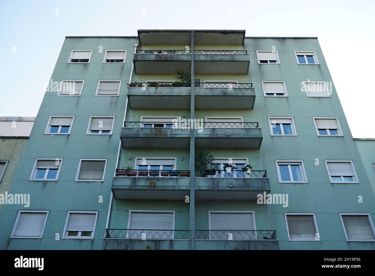 A low angle shot of an apartment building with old weathered exterior ...