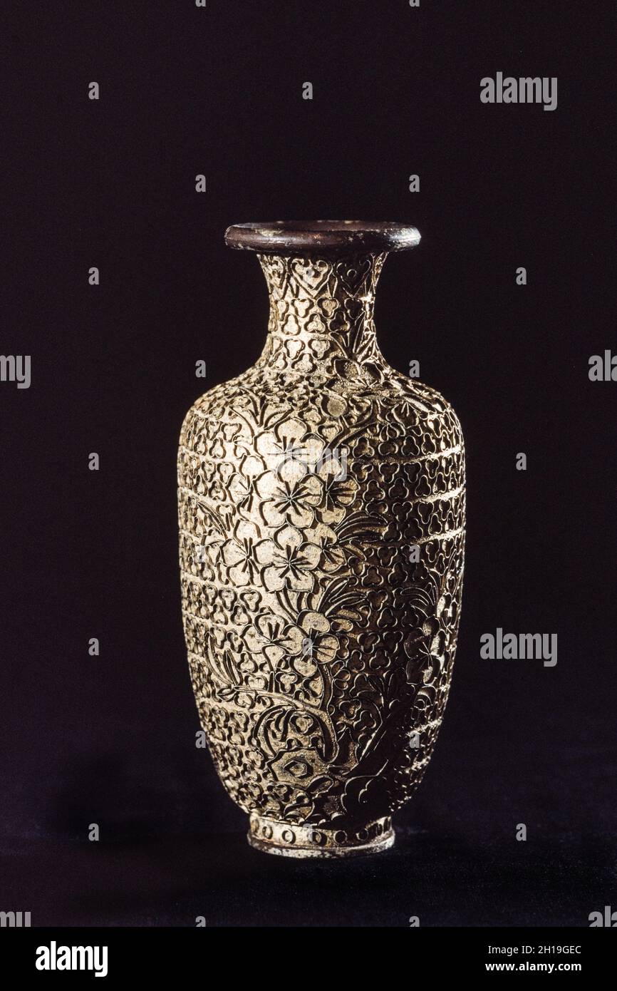 A bronze vase with the cloisons sintered on to be made into cloisonne in a workshop in Beijing, China. Stock Photo