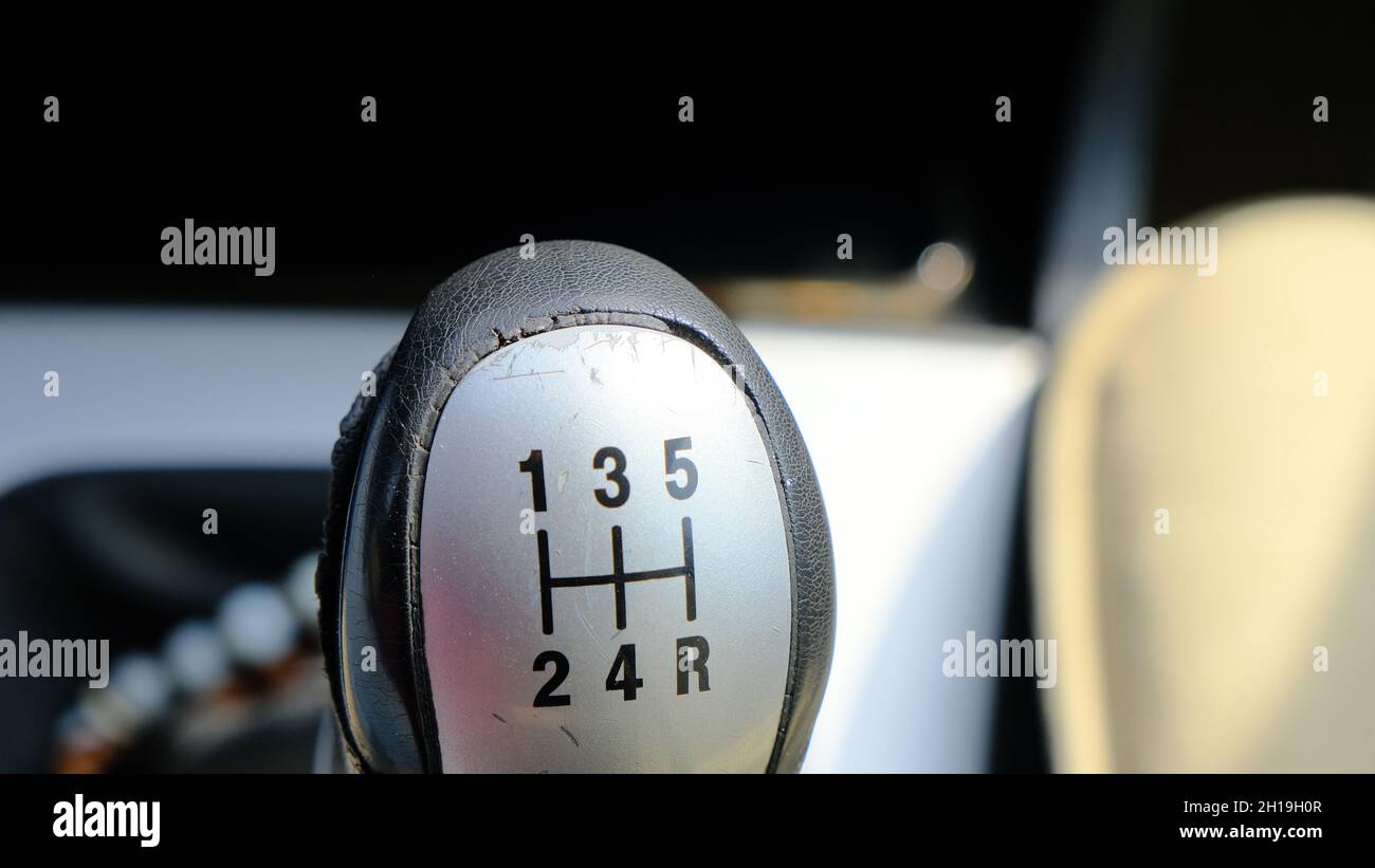 A manual car gears interior in car. 5 gears and one rear gear signs