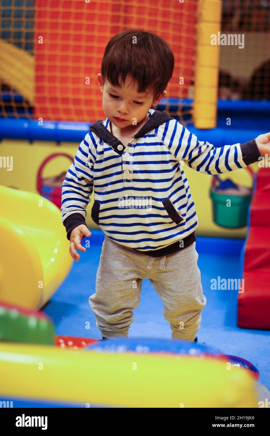 A young adorable Polish child playing in the indoor playground Stock
