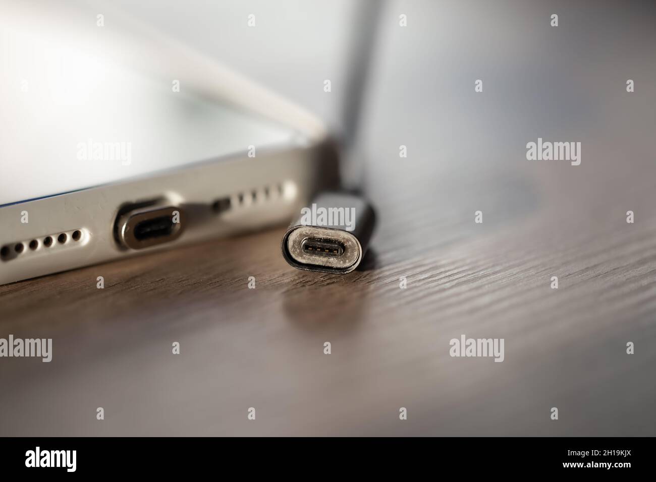 Magnetic cable for charging smartphone, close up. Stock Photo