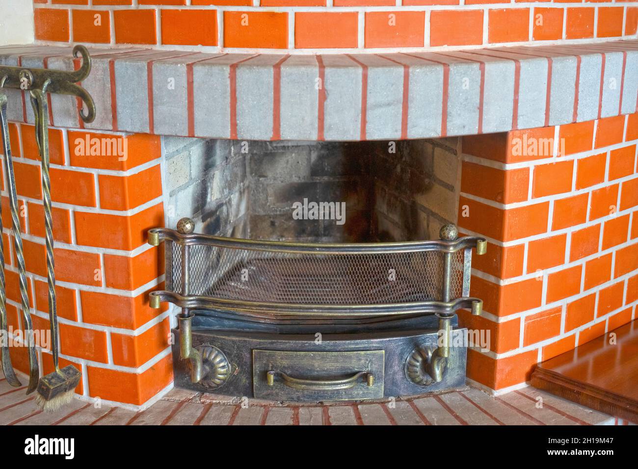 Large red brick fireplace in the interior. Stock Photo
