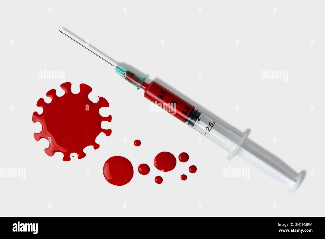 Syringe with blood drops on white background. Minimal Coronavirus outbreak. Pandemic concept. Stock Photo