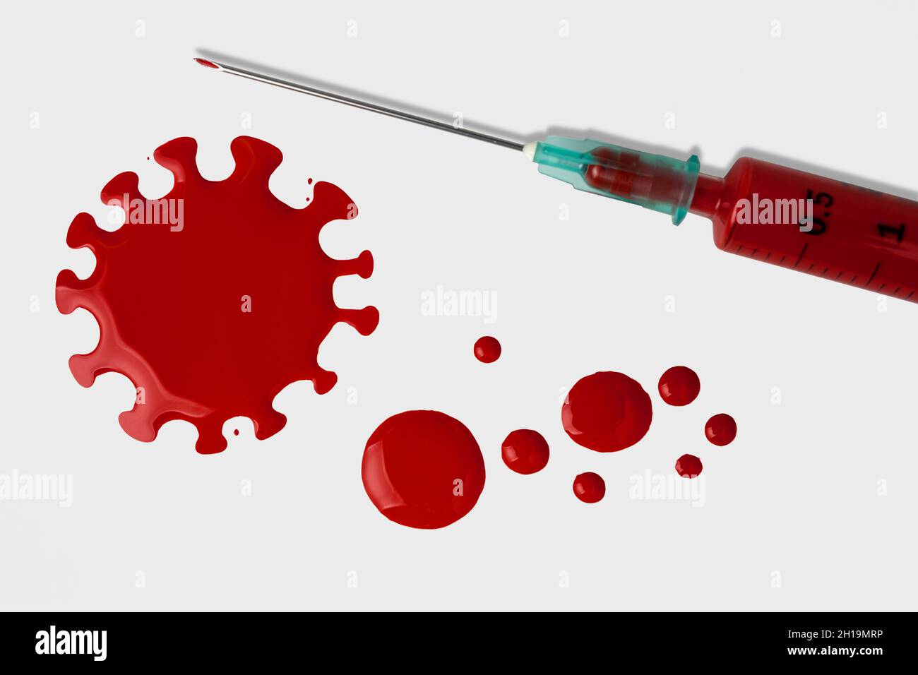Syringe with blood drops on white background. Minimal Coronavirus outbreak. Pandemic concept. Stock Photo