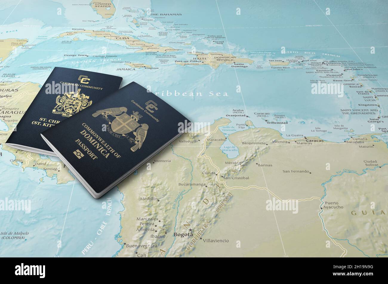 Passports of two Caribbean states, Saint Kitts and Nevis and Dominica on a map of the Caribbean Sea Stock Photo