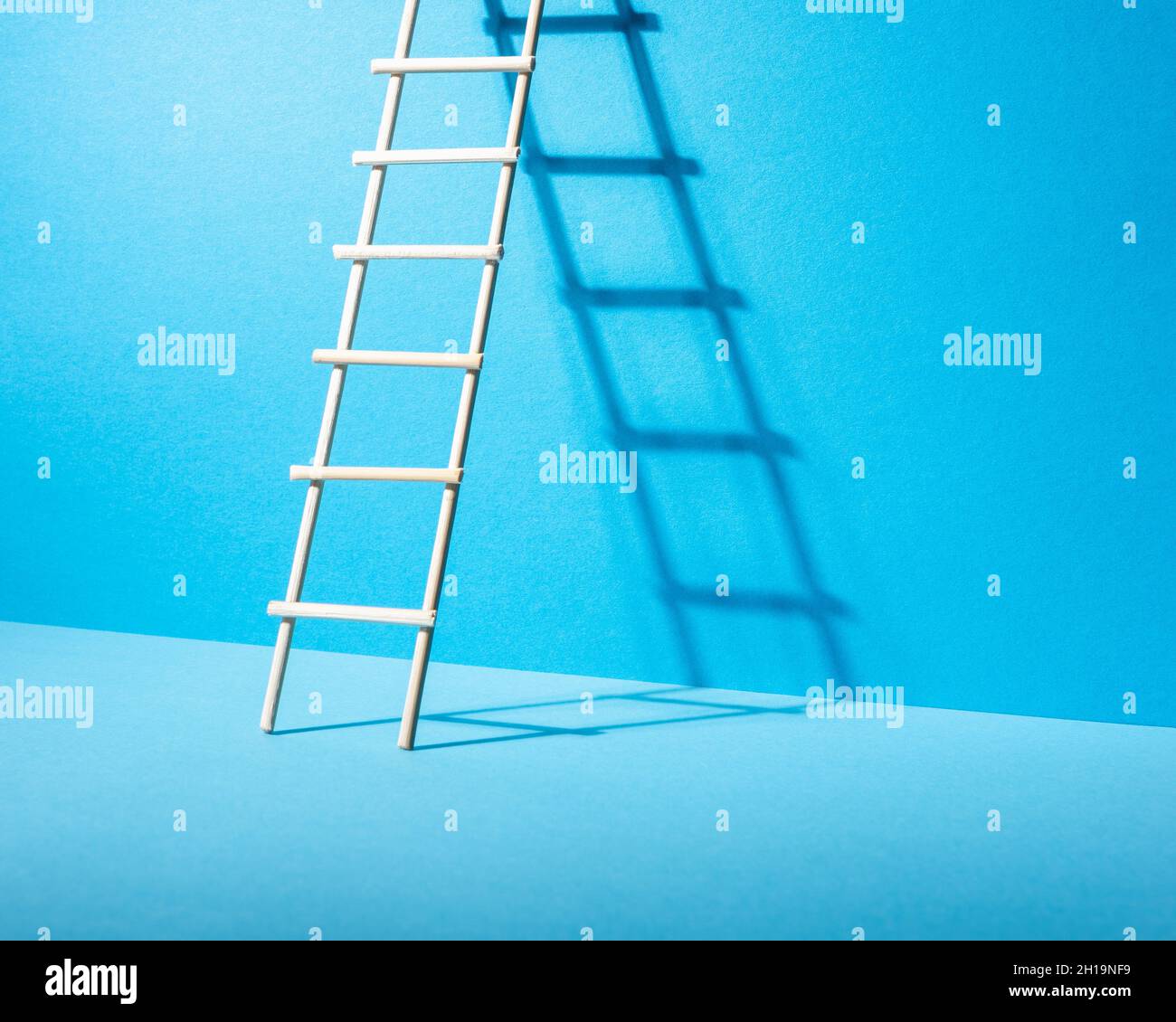 Stepladder on blue background. Success and progress concept. Minimal composition. Stock Photo