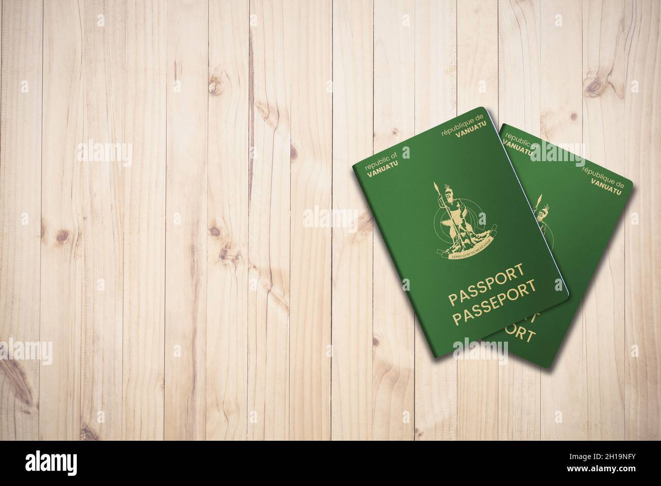 Two Vanuatu passports on a wooden background, citizenship by investment Stock Photo