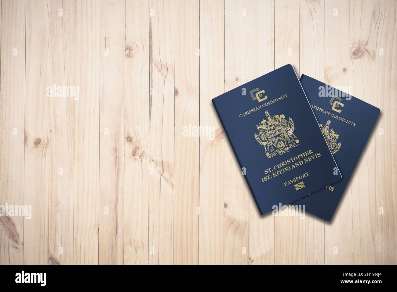 Two Saint Kitts and Nevis passports on a wooden background, citizenship by investment Stock Photo