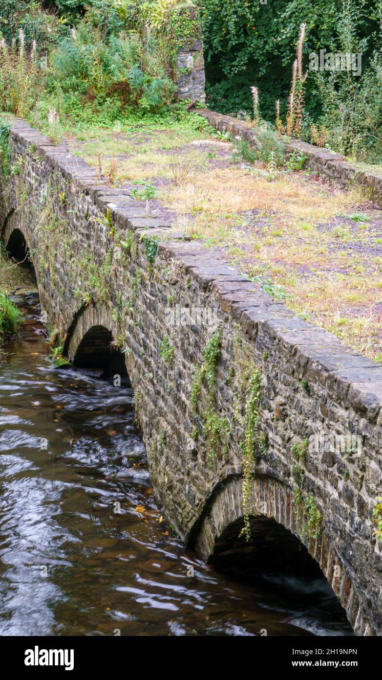 an arch stone bridge constructed over afon cegin at Penrhyn Dock, Bangor, Snowdonia Wales UK Stock Photo