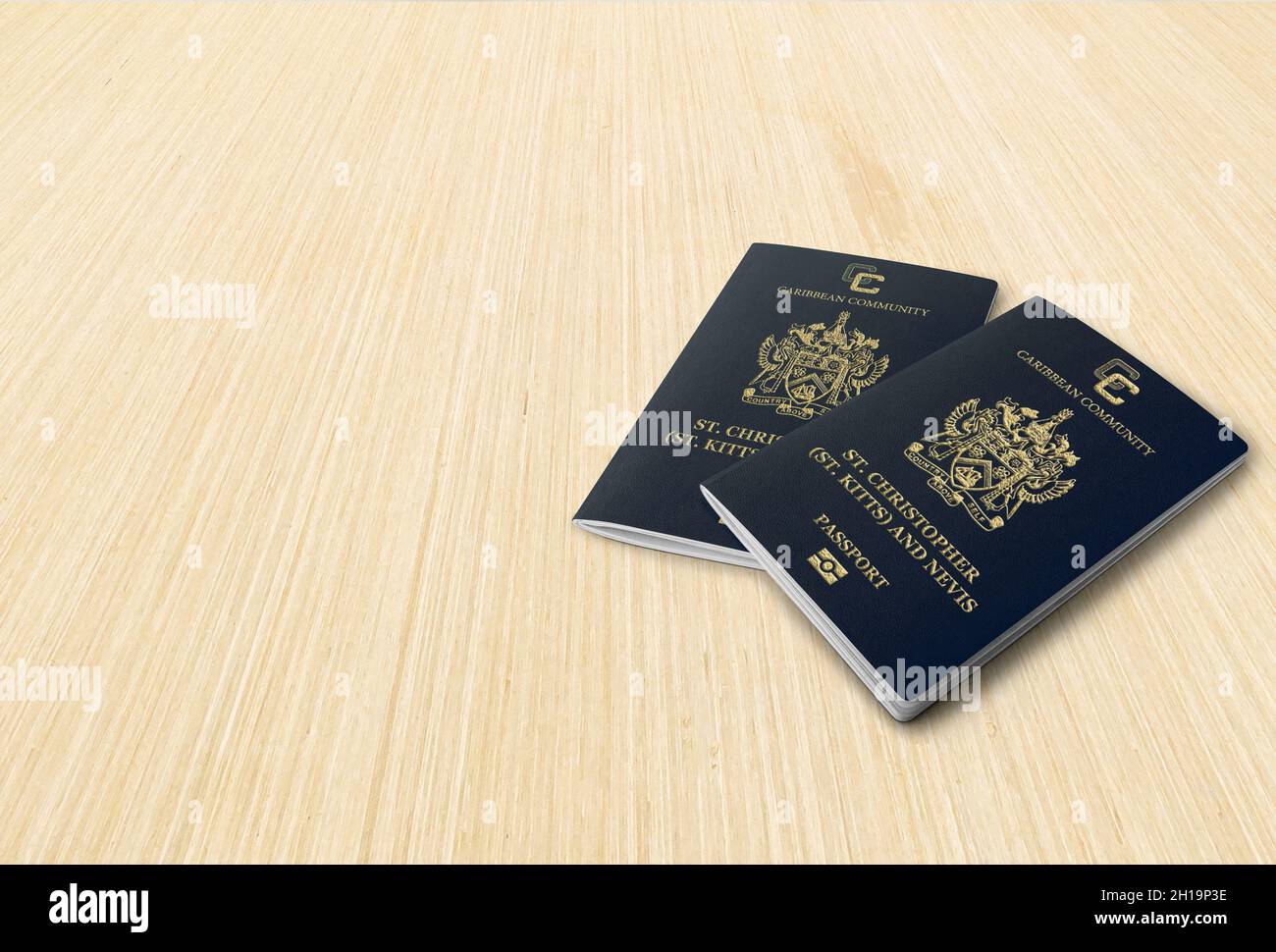 Two passports of Saint Kitts and Nevis against a background of wooden stripes, space for copies Stock Photo