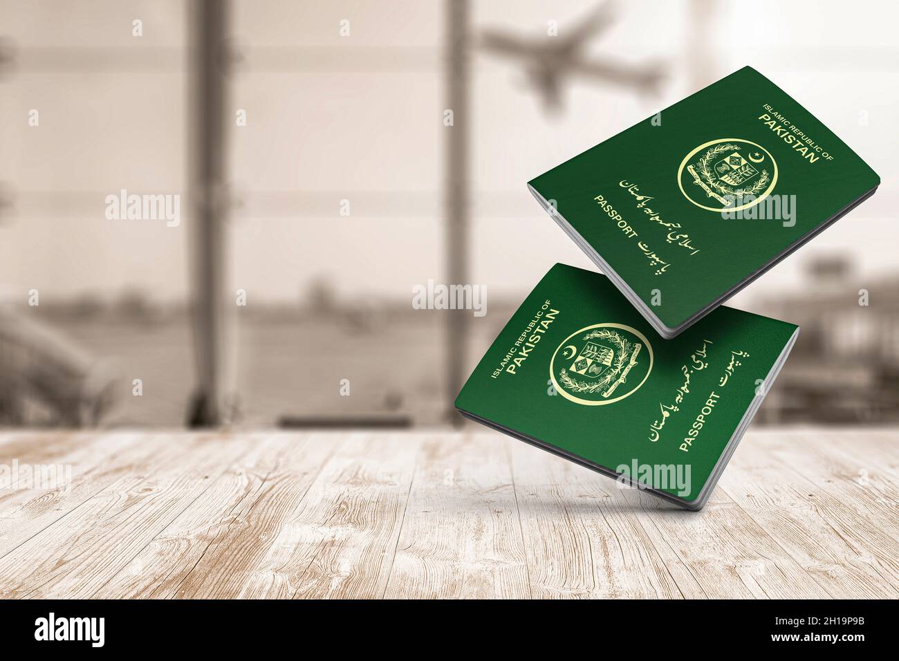Pakistan passport floats in the air on wooden table, copy space, Islamic Republic of Pakistan Stock Photo