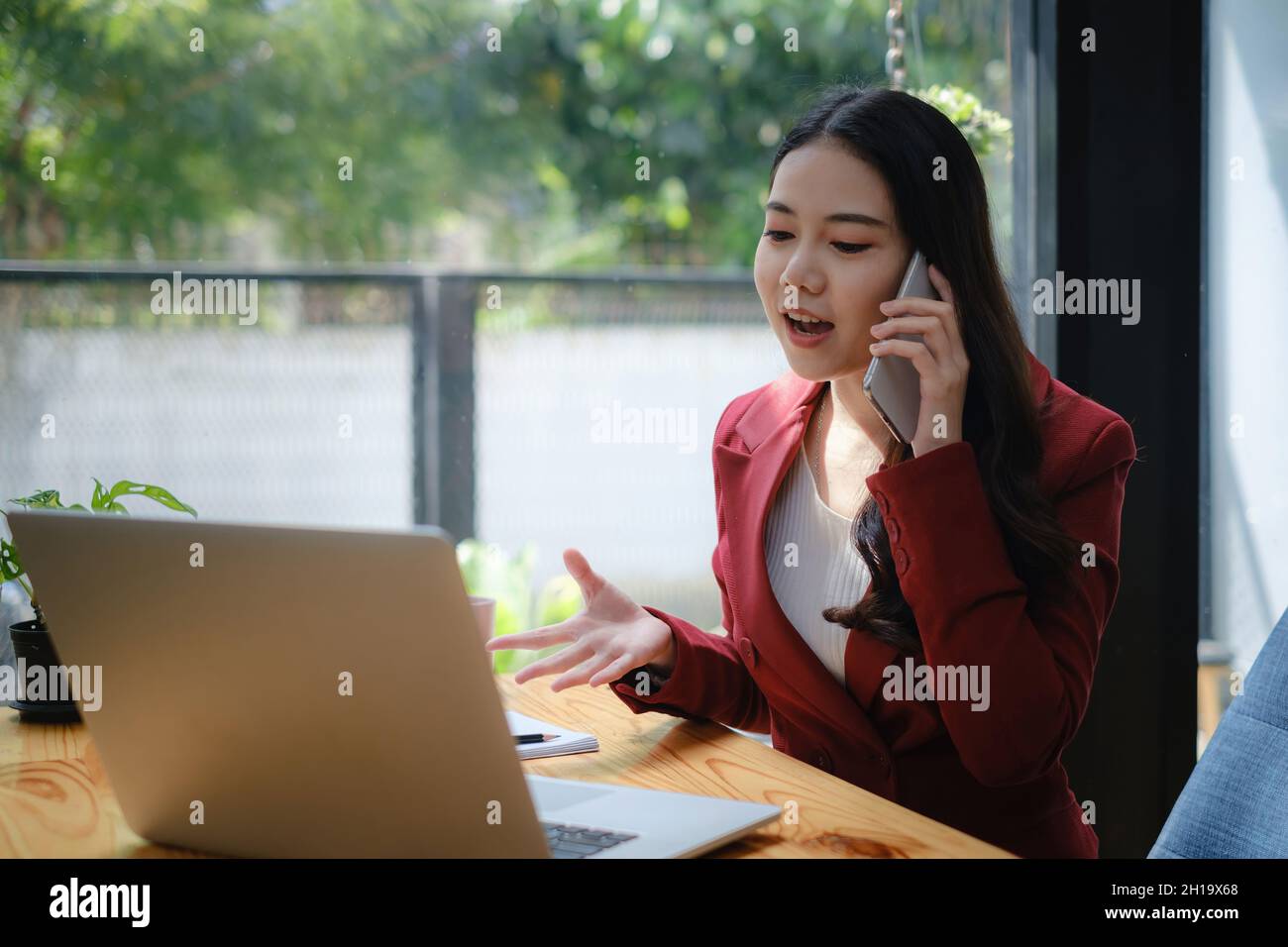 Beautiful business woman brief the project to team talkin by cell phone. Stock Photo