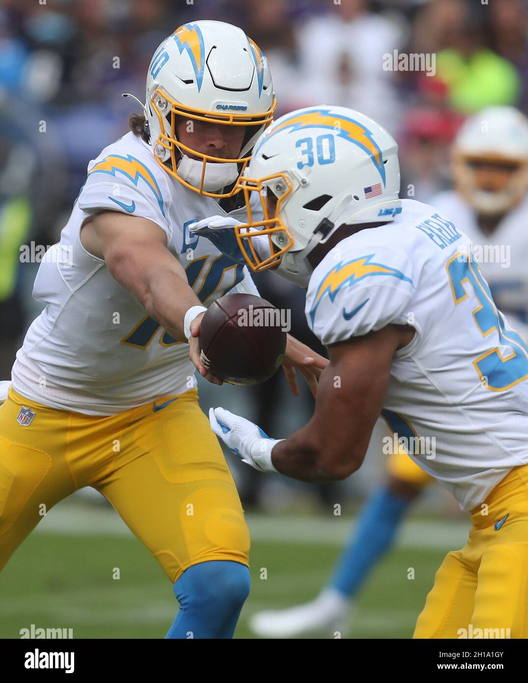 Los Angeles Chargers QB Justin Herbert (10) hands the ball off to Los Angeles Chargers RB Austin Ekeler (30) during a game against the Baltimore Ravens at M&T Bank Stadium in Baltimore, Maryland on October 17, 2021. Photo/ Mike Buscher/Cal Sport Media Stock Photo