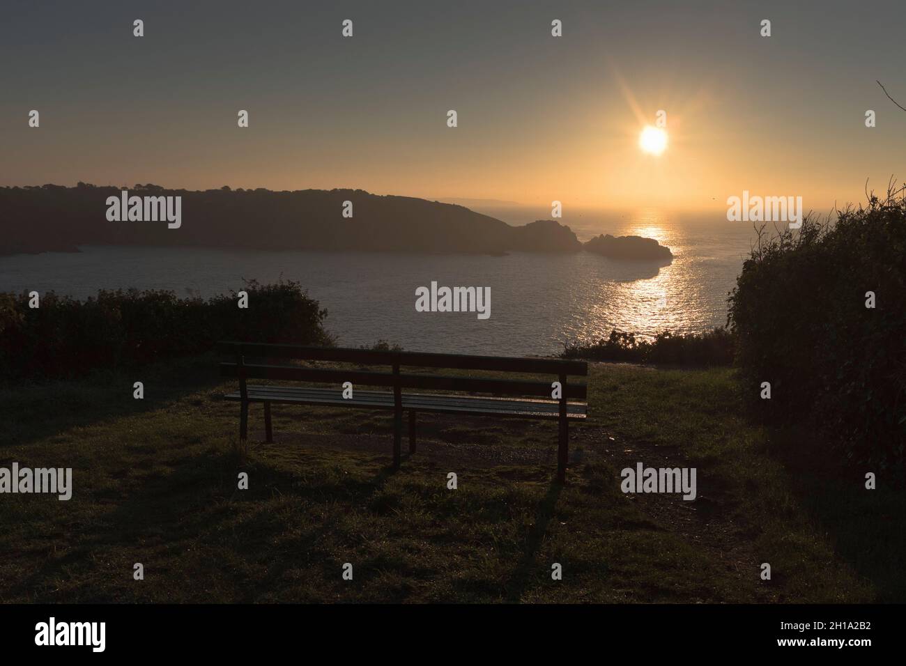 dh Jerbourg point ST MARTIN GUERNSEY Bench nobody early morning sunrise over Saint Martins southeast coast nopeople noone Stock Photo