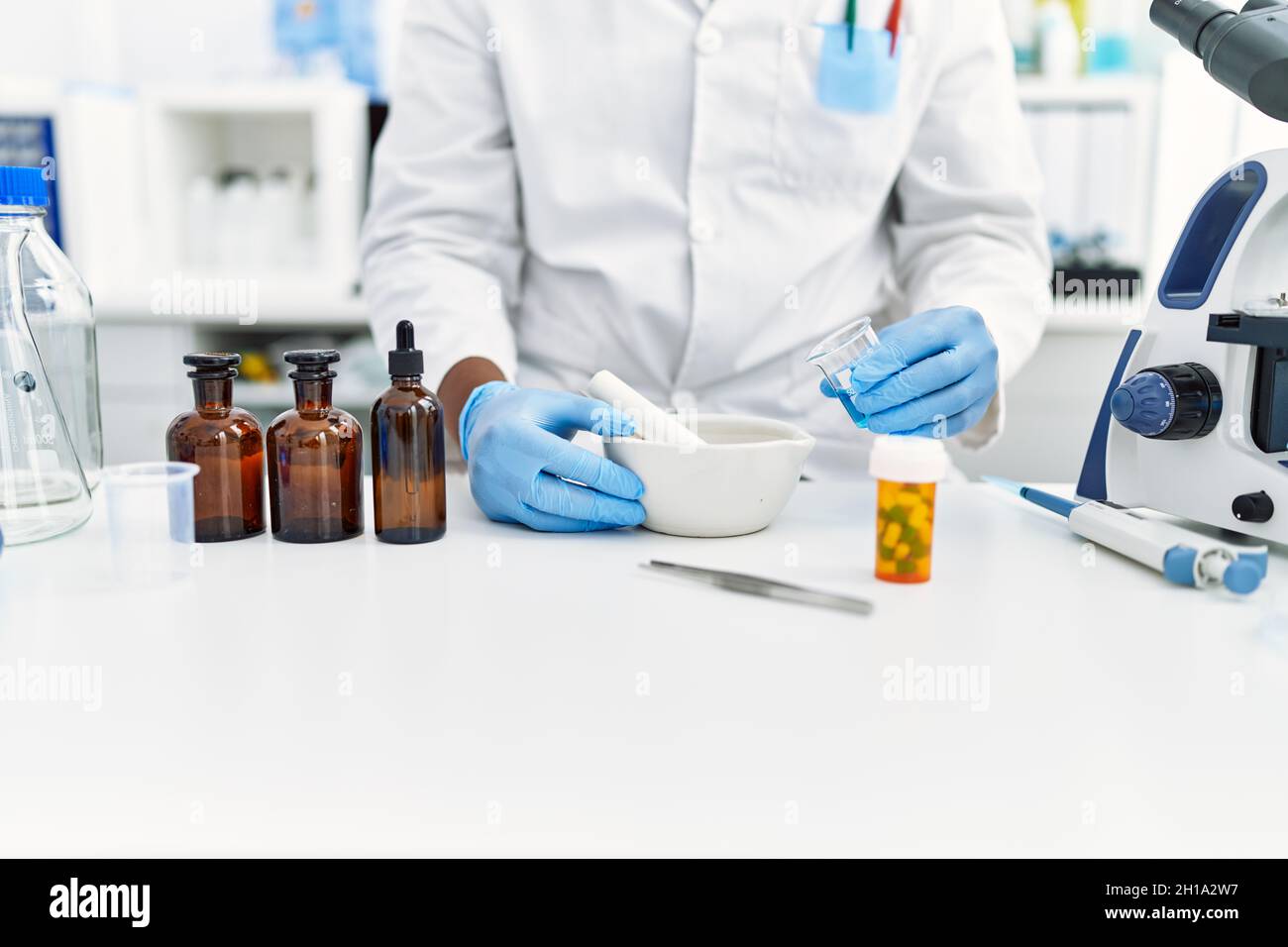 Lab Making Young south east man wearing scientist uniform making experiment at ...