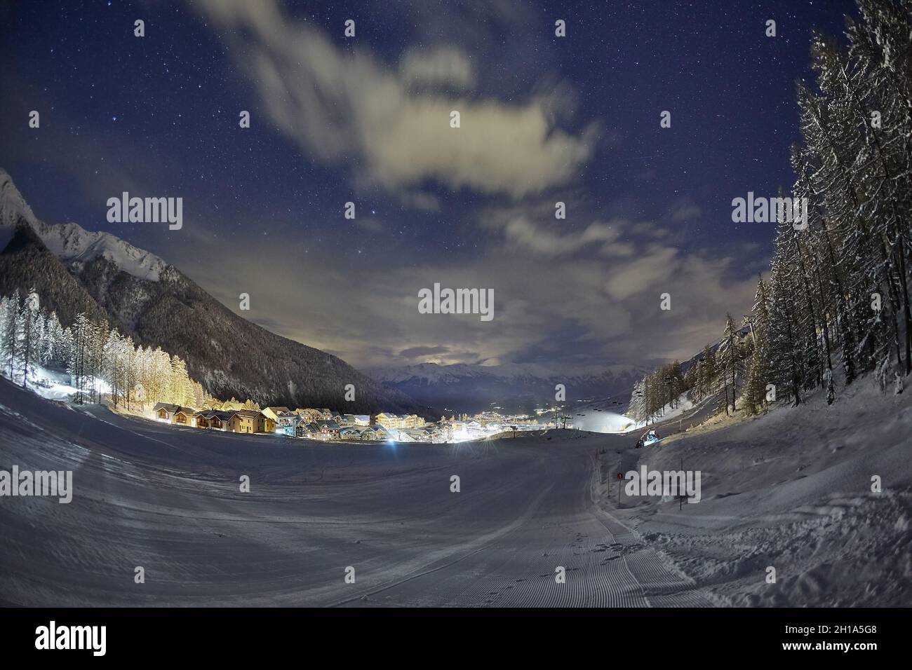 Ski slopes at night under the stars in the sky Stock Photo